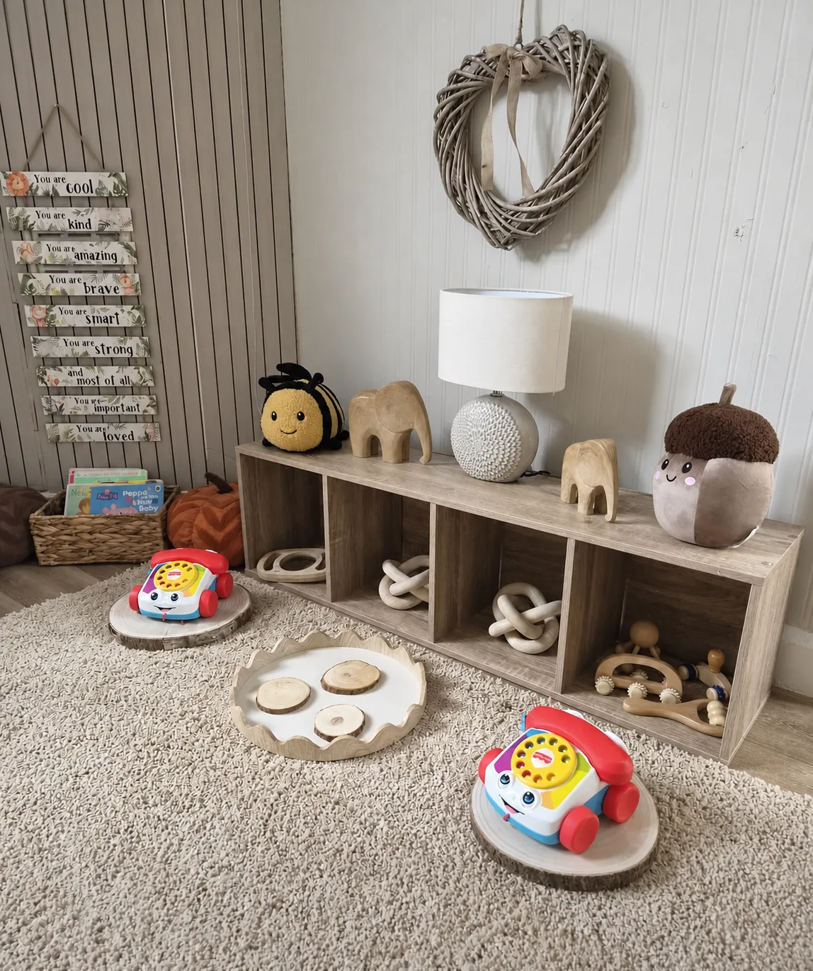 Low nursery shelving with natural play resources arranged for children to reach independently