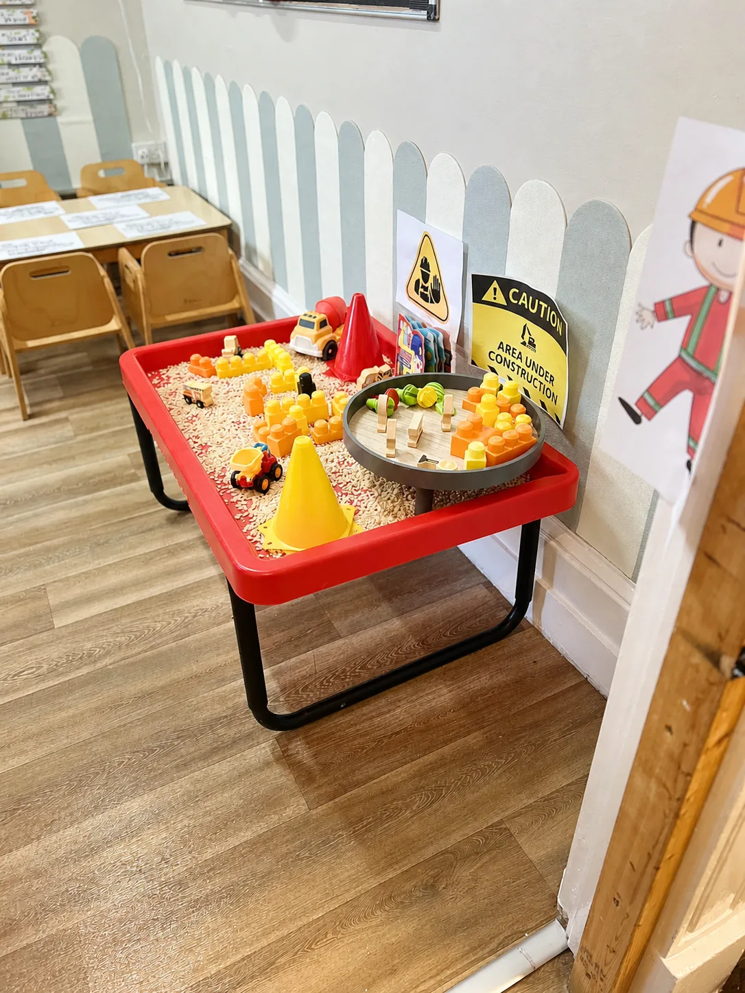 A builders small-world activity table with vehicles, blocks and construction signs