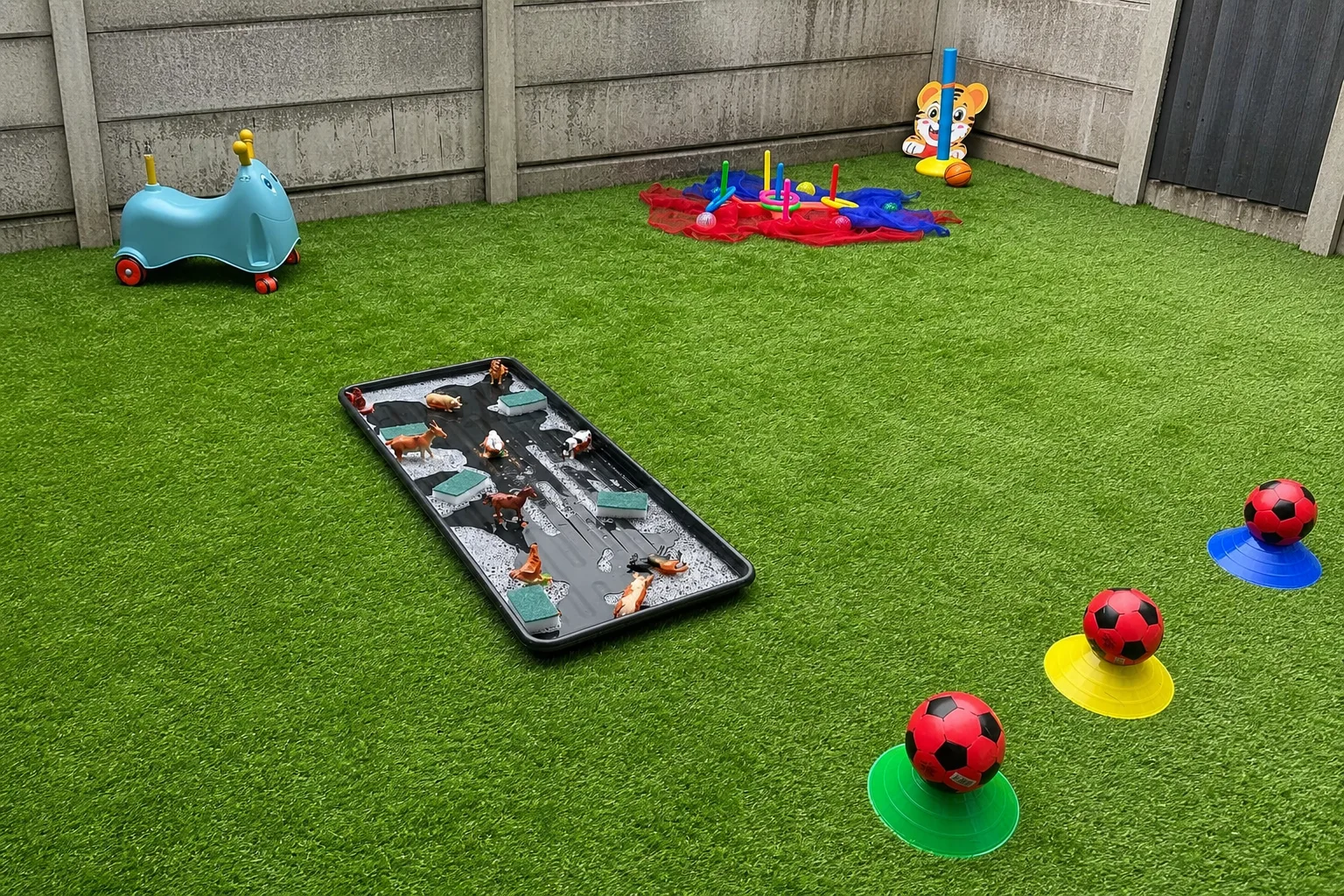 An outdoor activity course with football targets and a construction-themed play tray